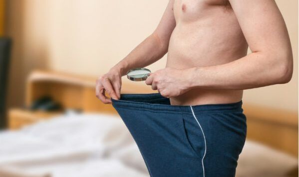 a man looks inside his pants and wants to increase his cock with pomp